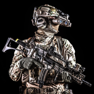 Soldier standing with a g36 tactical and night vision goggles.