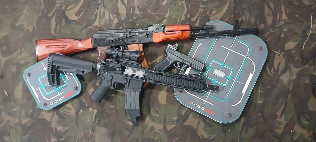 Airsoft Replicas on display with interactive target range target units on a camo background